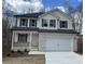 Charming two-story home featuring a brick facade, white siding, and a spacious two-car garage at 528 Earnest Ln, Temple, GA 30179