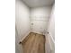 A compact laundry room with wood floors and wire shelving at 528 Earnest Ln, Temple, GA 30179