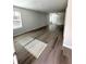 Bright living room showcasing new wood flooring and abundant natural light from the large windows at 528 Earnest Ln, Temple, GA 30179