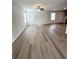 Spacious living room featuring wood-look flooring, ample natural light, and an open layout at 528 Earnest Ln, Temple, GA 30179