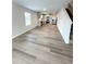 Inviting living area flowing into the modern kitchen, complete with stainless steel appliances and wood-look flooring at 528 Earnest Ln, Temple, GA 30179