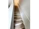 Carpeted staircase with a white railing at 528 Earnest Ln, Temple, GA 30179