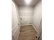 A functional laundry room features durable vinyl flooring and a wire shelf for efficient storage at 100 Deer Xing, Temple, GA 30179