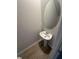 Cozy half bathroom with a modern sink, oval mirror, and tile flooring at 100 Deer Xing, Temple, GA 30179