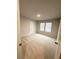 Bedroom with carpeted floor, a window with blinds, and a door at 127 Deer Xing, Temple, GA 30179