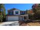 Two-story home with gray siding, white trim, black shutters, and a spacious two-car garage at 127 Deer Xing, Temple, GA 30179