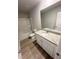 Bright bathroom featuring a tub-shower, granite vanity top and light wood-look flooring at 131 Deer Xing, Temple, GA 30179