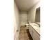 Bright bathroom featuring a tub-shower, granite vanity top and light wood-look flooring at 131 Deer Xing, Temple, GA 30179
