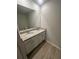 Bathroom view with double vanity with granite countertop and plank-style flooring at 131 Deer Xing, Temple, GA 30179