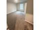 Bright bedroom with a window, neutral carpeting, and white walls at 131 Deer Xing, Temple, GA 30179