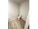 A compact toilet room featuring a standard toilet and vinyl plank flooring at 131 Deer Xing, Temple, GA 30179