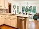Charming kitchen with stainless steel appliances, bar seating, and views of the wooded backyard at 1461 Fox Forest Sw Ter, Lilburn, GA 30047