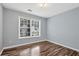 Bright bedroom featuring a large window and wood-look flooring at 285 Kentshire Pl, Lawrenceville, GA 30044