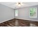 Bright bedroom featuring a ceiling fan, gray walls, and hardwood flooring at 285 Kentshire Pl, Lawrenceville, GA 30044