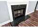 Traditional fireplace with dark green tile and decorative white mantle adds warmth to this cozy living space at 285 Kentshire Pl, Lawrenceville, GA 30044