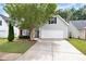 Charming home featuring a two-car garage and a well-maintained front yard with mature landscaping at 285 Kentshire Pl, Lawrenceville, GA 30044