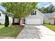 Charming home featuring a two-car garage and a well-maintained front yard with mature landscaping at 285 Kentshire Pl, Lawrenceville, GA 30044