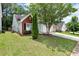 View of the house featuring mature landscaping and a well-manicured lawn at 285 Kentshire Pl, Lawrenceville, GA 30044