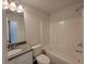 Bright bathroom featuring a shower-tub combo, granite counters, and modern fixtures at 451 Courthouse Park Dr, Temple, GA 30179