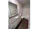 Full bathroom with granite vanity and shower-tub, wood look flooring and white paint at 451 Courthouse Park Dr, Temple, GA 30179