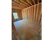 Framed bedroom under construction features a window with natural light, awaiting personalized design and finishing touches at 451 Courthouse Park Dr, Temple, GA 30179