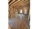 Under-construction living room with stud framing and a doorway, ready for customization to reflect your personal style at 451 Courthouse Park Dr, Temple, GA 30179