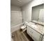 Bathroom with white vanity, granite countertop, and tub with shower at 836 Courthouse Park Dr, Temple, GA 30179