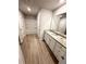 Bathroom with wood-look floors, white cabinets, and granite countertop at 836 Courthouse Park Dr, Temple, GA 30179