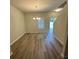 Bright dining room with wood-look floors and modern chandelier at 836 Courthouse Park Dr, Temple, GA 30179