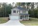 Charming two-story home featuring a covered porch, two-car garage, and landscaped front yard at 836 Courthouse Park Dr, Temple, GA 30179