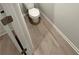 Powder room with wood-look floors and a modern toilet at 836 Courthouse Park Dr, Temple, GA 30179