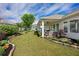 A backyard featuring a well maintained lawn, rock bordered flowerbeds, and a covered patio at 250 Cordova St, Woodstock, GA 30189