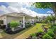 A backyard featuring a covered patio with ample seating, a manicured lawn, and lush landscaping at 250 Cordova St, Woodstock, GA 30189