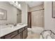 Neutral bathroom featuring a single sink vanity, shower with tile surround, and a modern aesthetic at 250 Cordova St, Woodstock, GA 30189