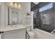 Modern bathroom with black tiled shower, white vanity, and chrome fixtures, creating a sleek design at 250 Cordova St, Woodstock, GA 30189