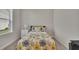 Cozy bedroom featuring a comfortable bed with floral patterned bedding, a white nightstand, and natural light at 250 Cordova St, Woodstock, GA 30189