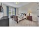 Cozy bedroom featuring soft carpet, a comfortable bed, and a mounted television at 250 Cordova St, Woodstock, GA 30189