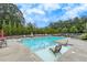 A spacious community pool with lounge chairs, landscaped surroundings, and clear blue water at 250 Cordova St, Woodstock, GA 30189