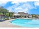 A community pool is surrounded by lounge seating and an adjacent clubhouse at 250 Cordova St, Woodstock, GA 30189