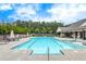 A long community pool is surrounded by lounge seating and an adjacent clubhouse at 250 Cordova St, Woodstock, GA 30189