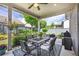 Charming covered patio featuring a ceiling fan, outdoor dining set, and a grill with picturesque backyard views at 250 Cordova St, Woodstock, GA 30189