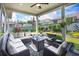 Comfortable covered patio with stylish outdoor seating, ceiling fan, and a lovely view of the landscaped backyard at 250 Cordova St, Woodstock, GA 30189