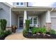 Inviting front porch with seating area, decorative plants, and a stylish entryway at 250 Cordova St, Woodstock, GA 30189