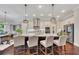 Kitchen island with seating, stainless appliances, and stylish pendants at 250 Cordova St, Woodstock, GA 30189