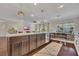 Open-concept kitchen island with granite countertop, stainless steel appliances, and stylish pendant lighting at 250 Cordova St, Woodstock, GA 30189