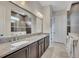 Main bathroom with double vanity, granite countertops, large mirror, and tile flooring at 250 Cordova St, Woodstock, GA 30189