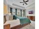 Comfortable main bedroom with tray ceiling, large windows, TV, and hardwood furniture at 250 Cordova St, Woodstock, GA 30189