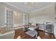 Home office with wood floors, a stylish desk and seating, and elegant french doors at 250 Cordova St, Woodstock, GA 30189