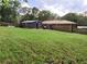 Large backyard featuring a brick home, storage shed, and mature trees at 4179 Westview St, Douglasville, GA 30135