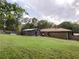 The expansive backyard features a storage shed, brick home, and lush lawn at 4179 Westview St, Douglasville, GA 30135